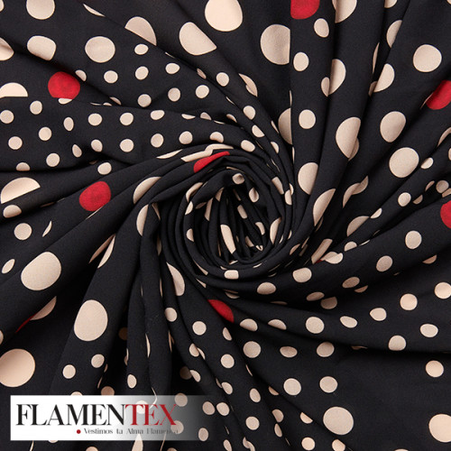 Tejido tipo georgette con estampado de lunares de diferentes medidas.