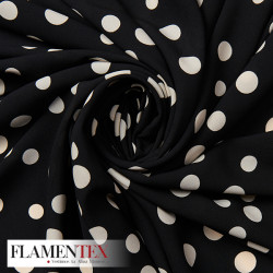 Tejido tipo georgette un poco más tupido y algo elástico. Estampado de lunares locos de diferentes tamaños.